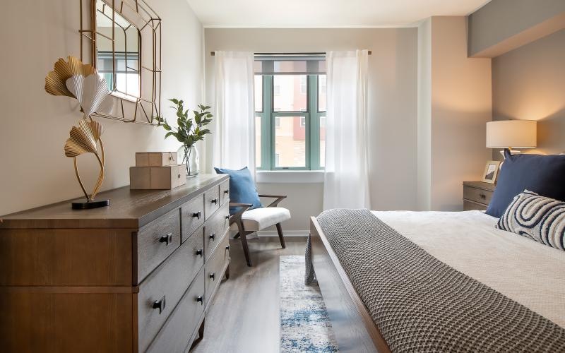 a bedroom with a bed and a chair
