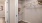 a closet in a bathroom with shelves and hangers