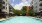 a swimming pool in a courtyard between buildings